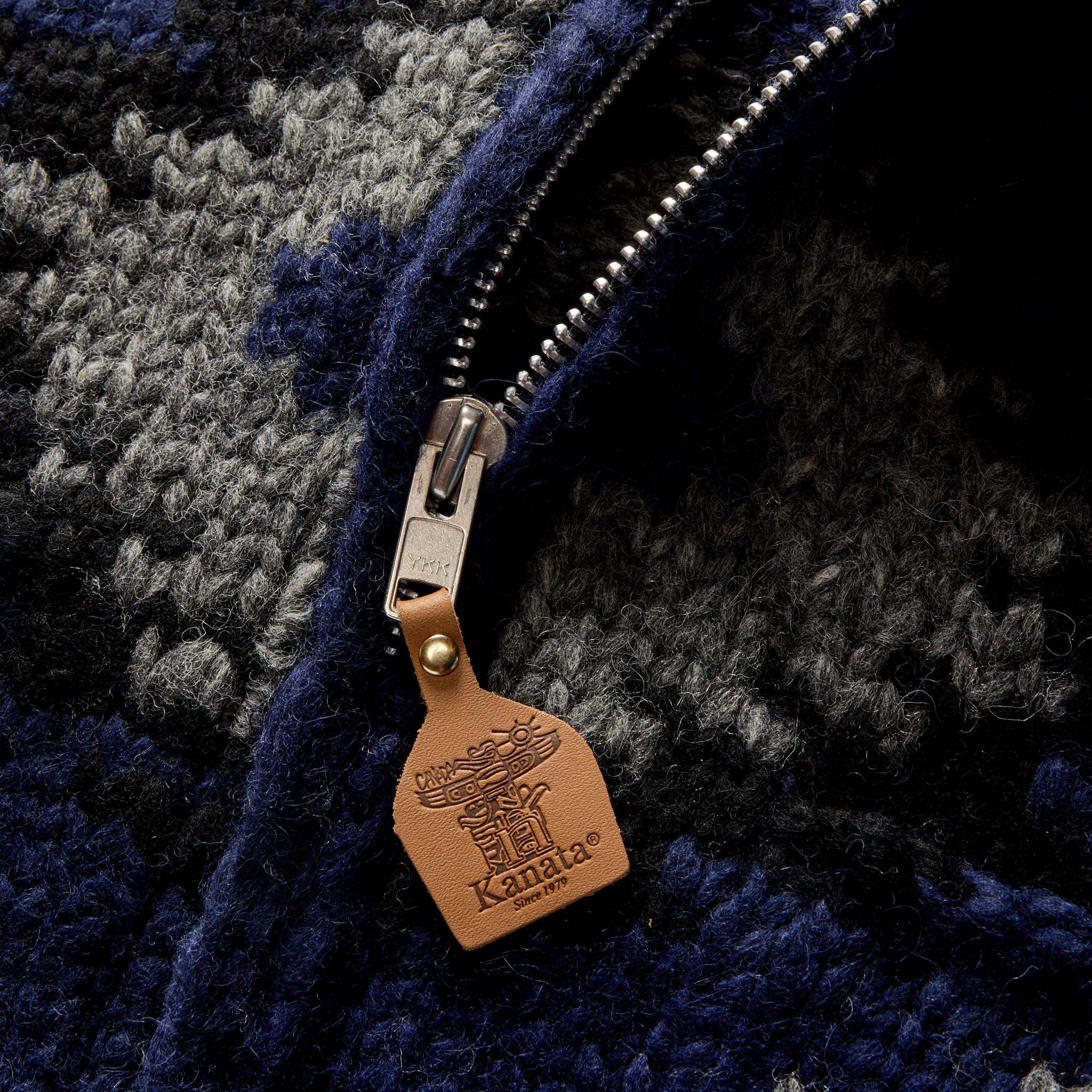 material shot of the leather zipper tab on The Seawall Hand-Knit Sweater in Navy Kilim, Knits by Taylor Stitch