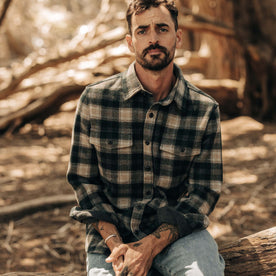 fit model sitting in The Maritime Shirt Jacket in Dried Pine Plaid