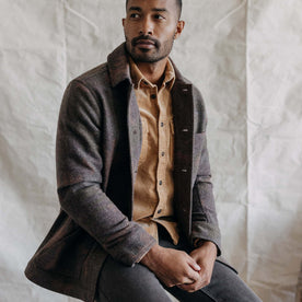 fit model sitting in The Ojai Jacket in Heathered Camo Wool