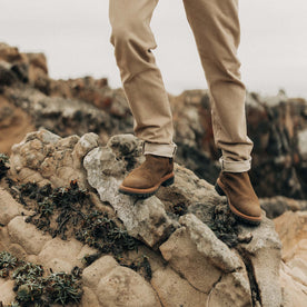 fit model on rocks in The Ranch Boot in Golden Brown Waxed Suede