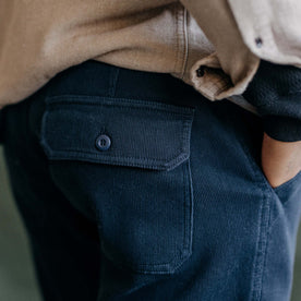 fit model showing the back button-through pockets on The Trail Pant in Dark Navy Bedford Cord