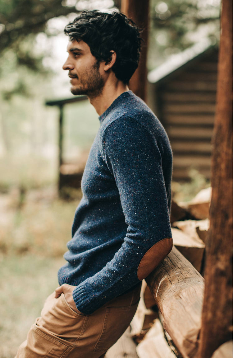 The Hardtack Sweater in Navy Donegal — Model from the left leaning up against cabin