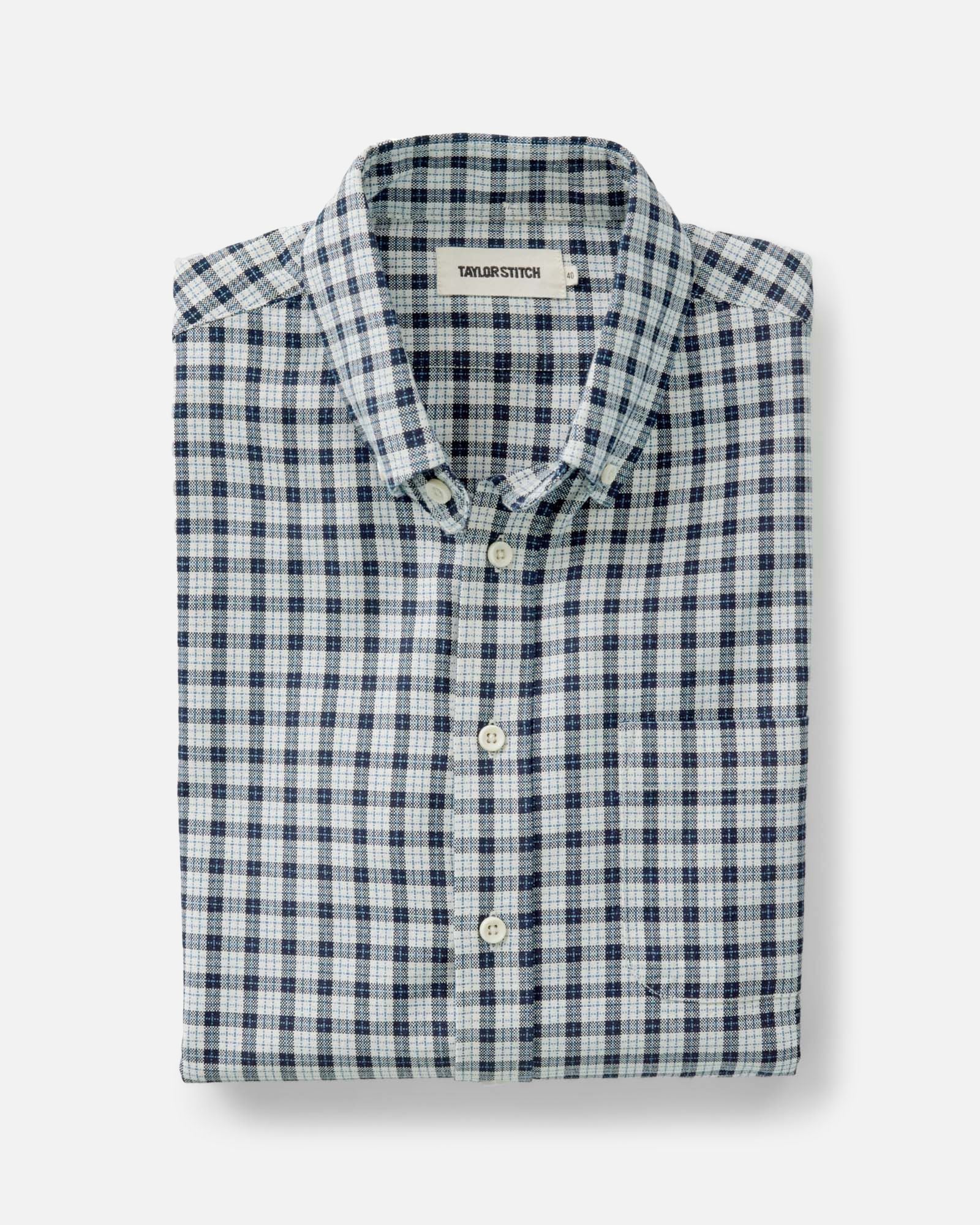 folded flatlay of The Jack in Indigo Micro Check Oxford, Wovens by Taylor Stitch