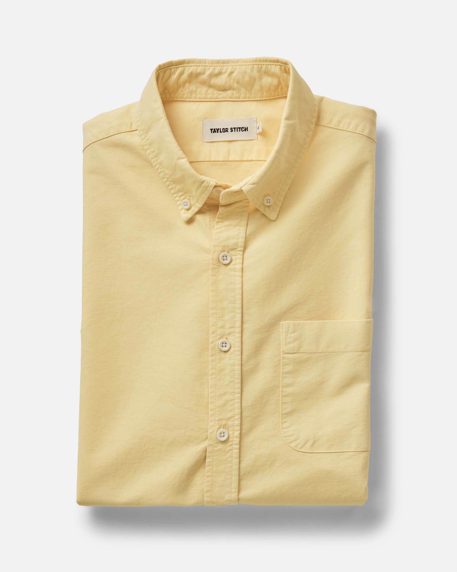 folded flatlay of The Jack in Straw Oxford, Wovens by Taylor Stitch