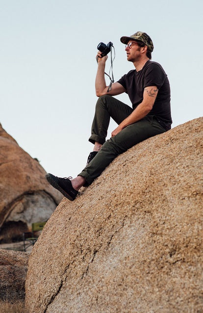 Sitting on a rock, snapping photos.