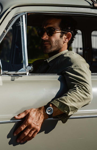 Model in his car wearing the Timex Black max