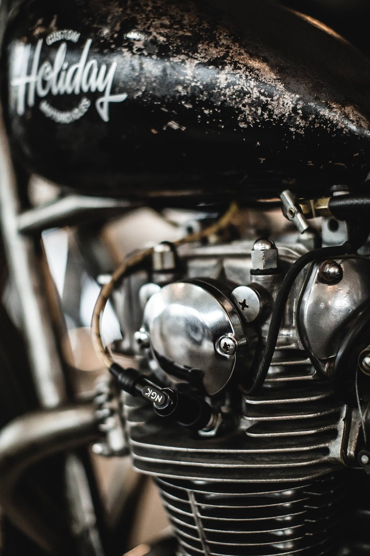 Close up on the frame and engine of a black vintage motorcycle.