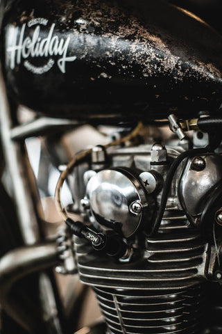 Close up on the frame and engine of a black vintage motorcycle.