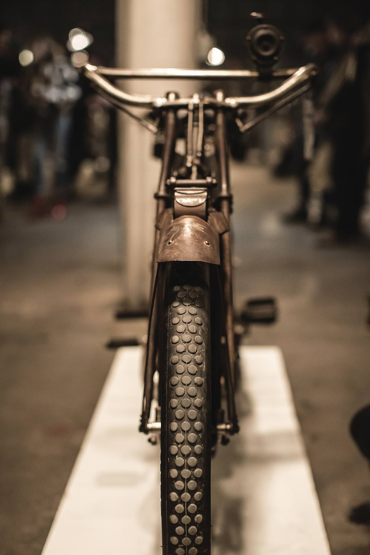 Rear-on shot of a thin-tired and -framed motorbike.