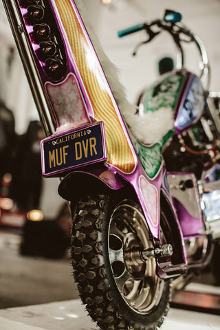 Color-saturated image featuring a 1970s era high seat-backed chopper.