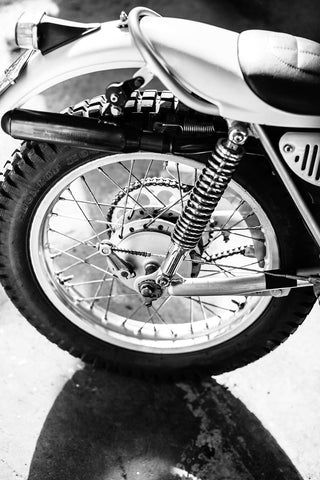 Black and white image of the rear section of a motorcycle.