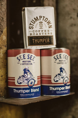 Cans of Stumptown coffee on a shelf.