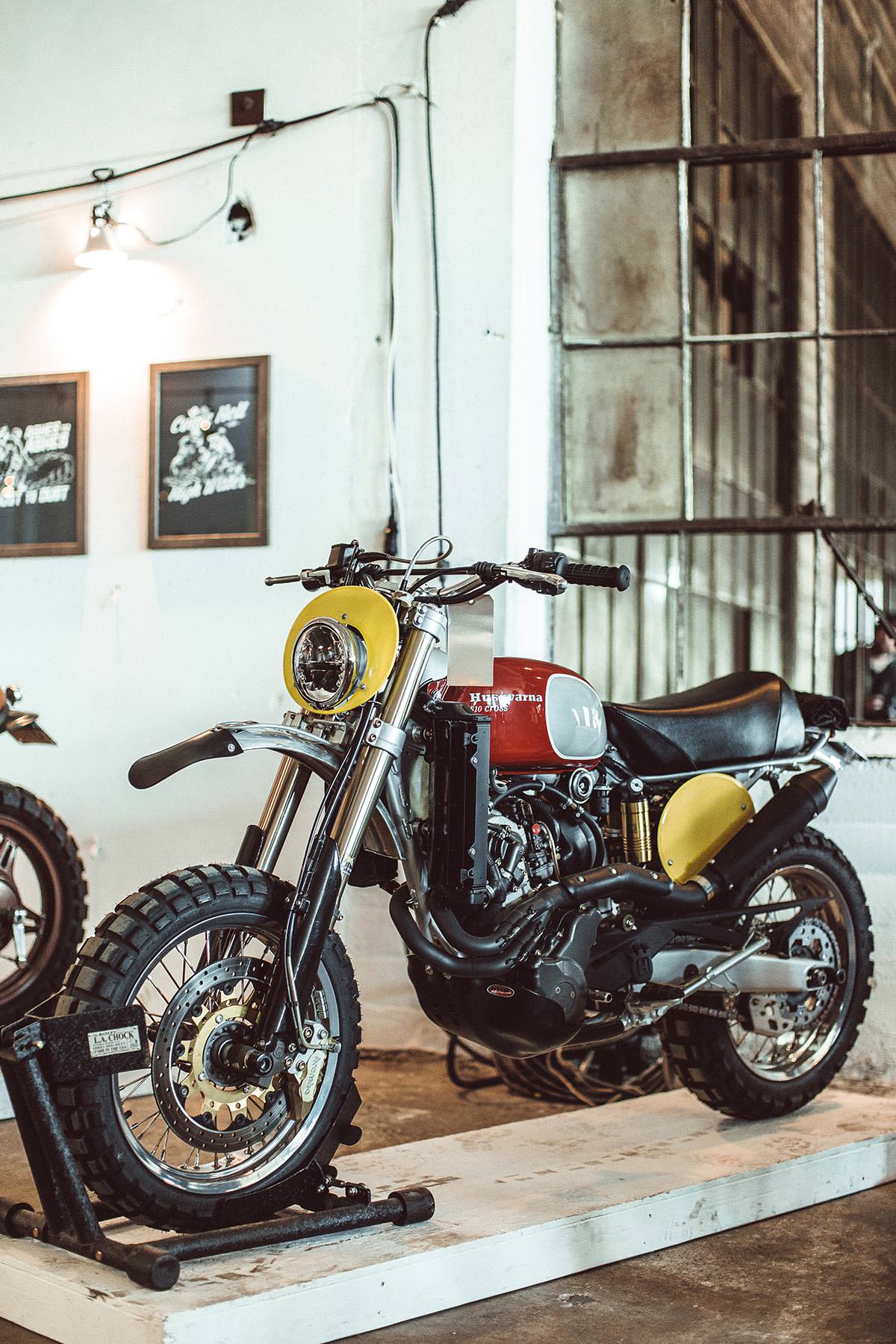 A vintage motorcycle displayed in an industrial setting.
