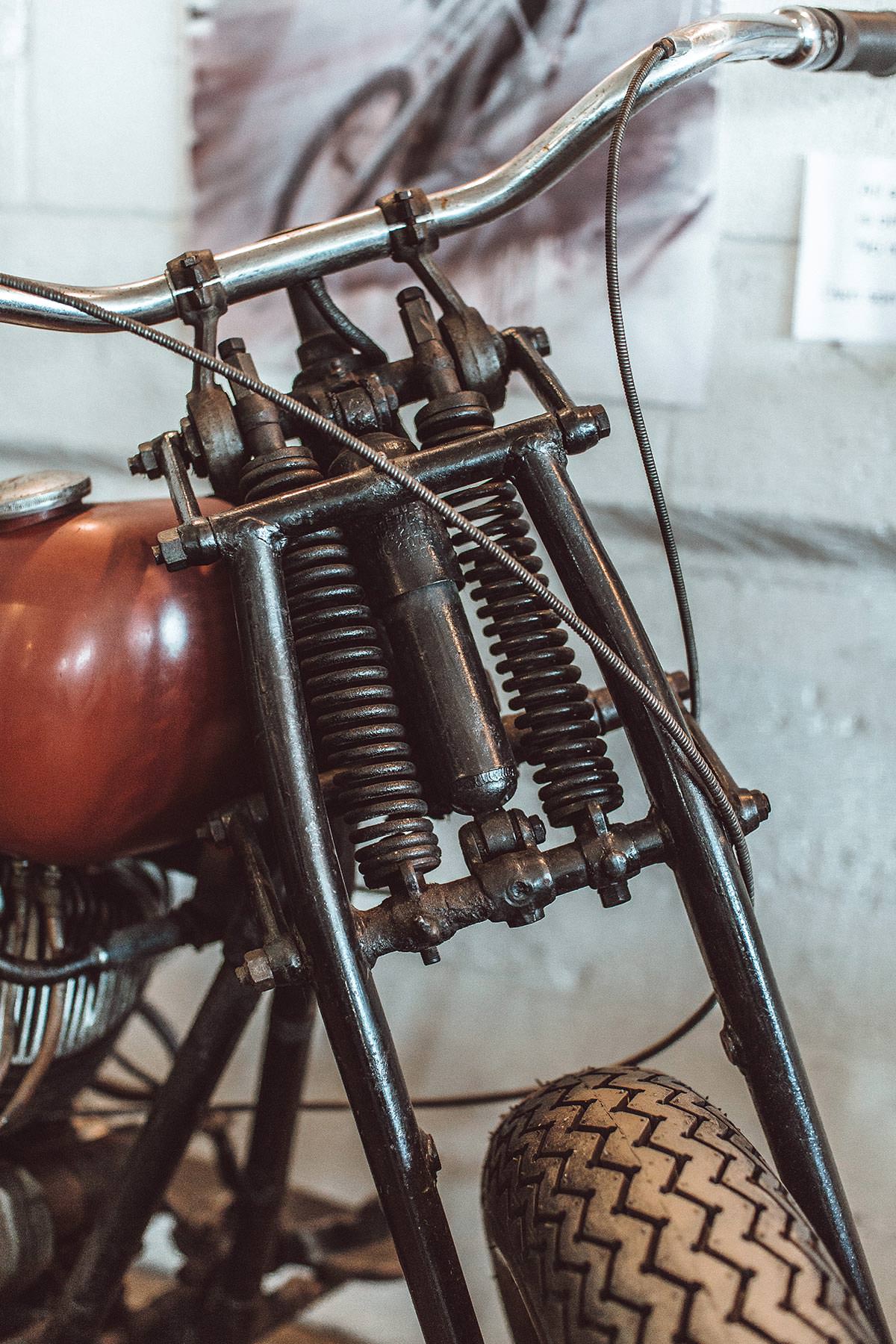 Close up shot of the front fork and springs on a vintage moto.
