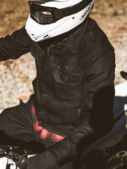 Overhead shot of moto rider showing long haul denim jacket up close.