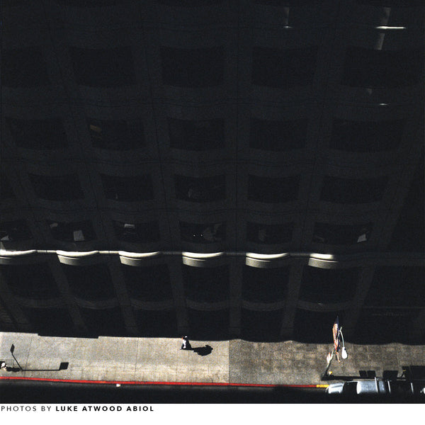 shot of luke in the city, wearing the ojai layered over a shirt