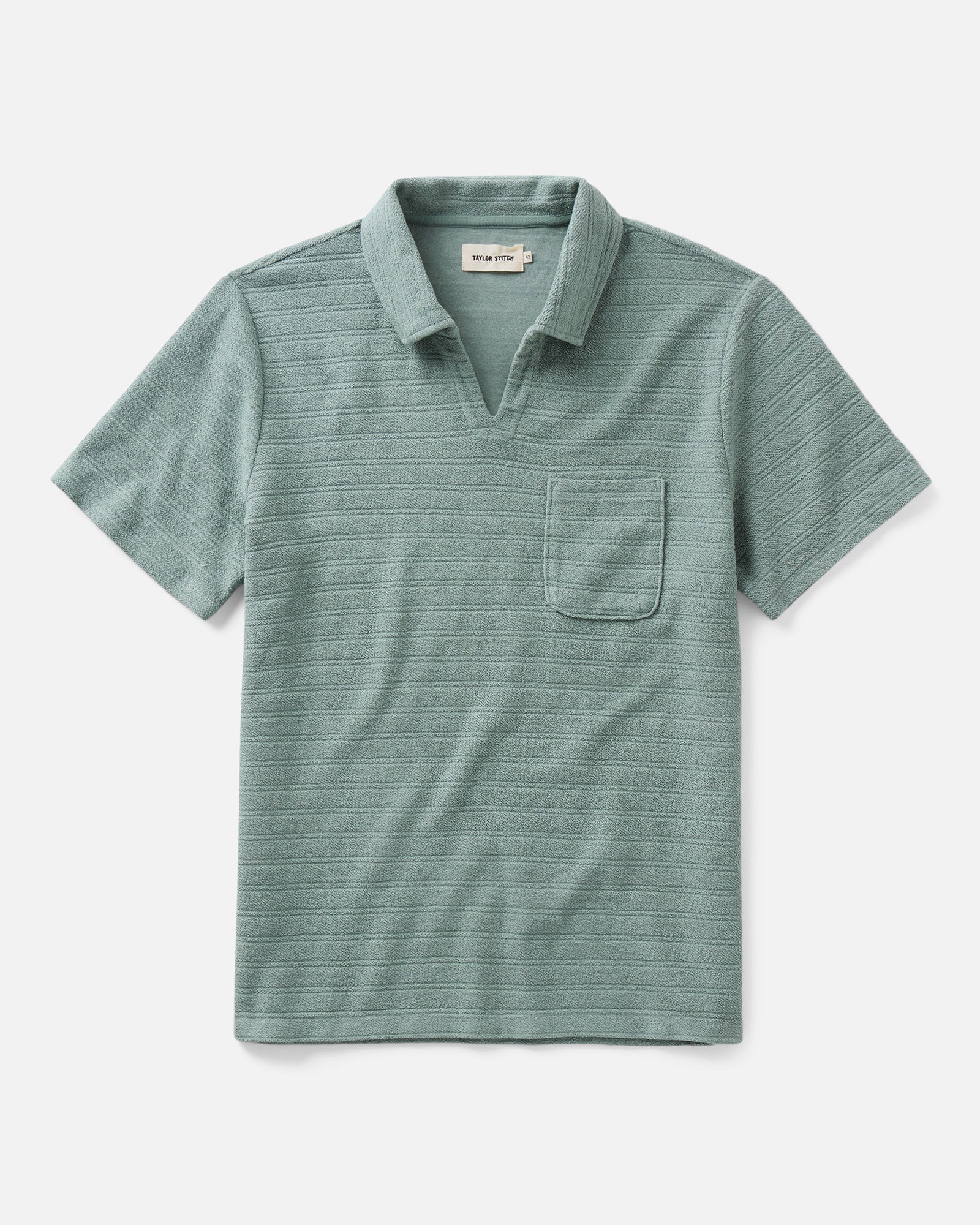 flatlay of The Meridian Polo in Faded Pine, Knits by Taylor Stitch