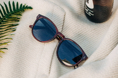 the Nelson sunglasses atop our Nomad Hoodie with a bottle of iced coffee