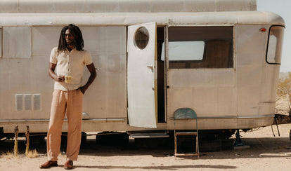 fit model sitting wearing The Breakwater Pant in Chili Stripe Linen