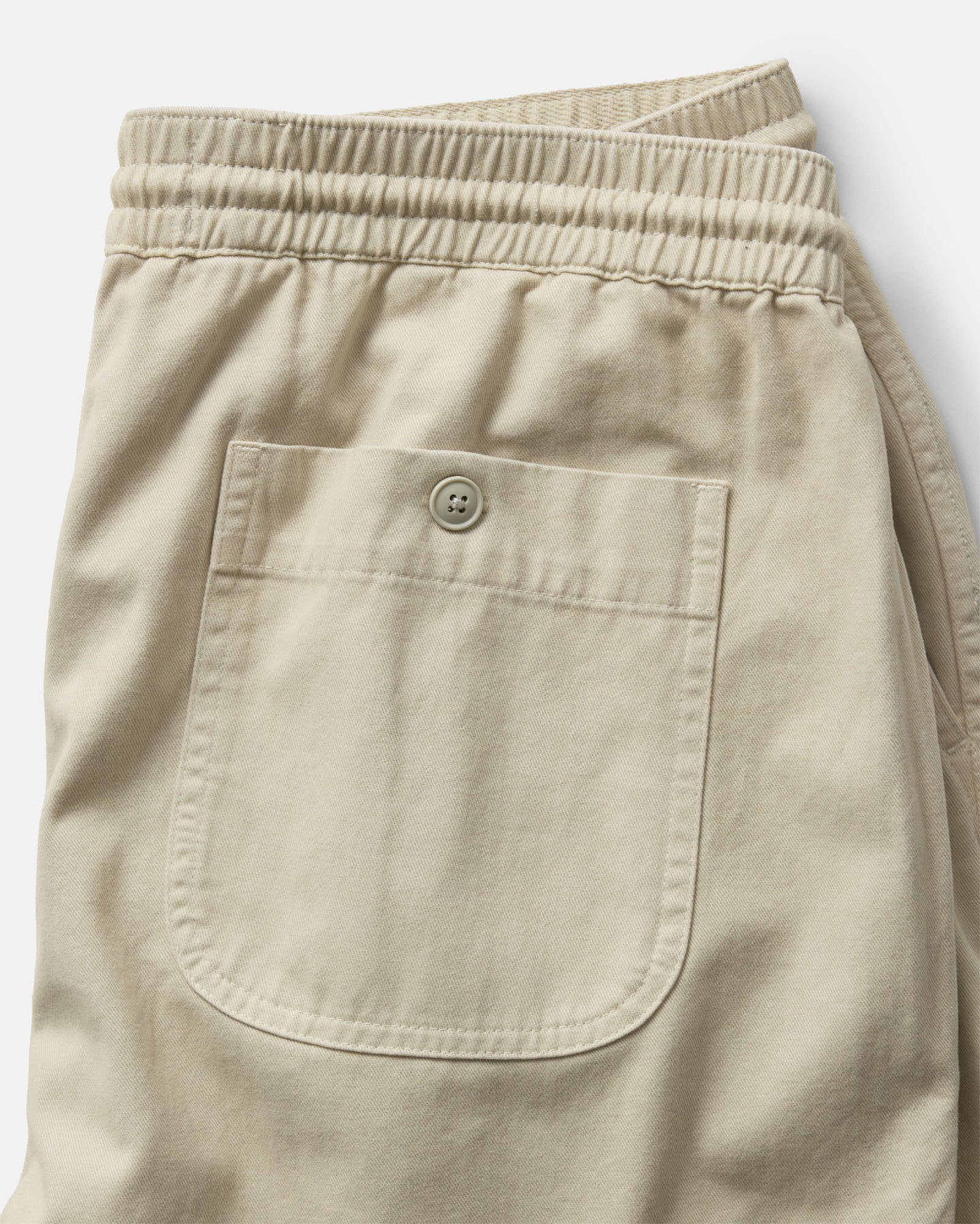 material shot of the back of The Apres Short in Organic Aged Stone Foundation Twill, Bottoms by Taylor Stitch