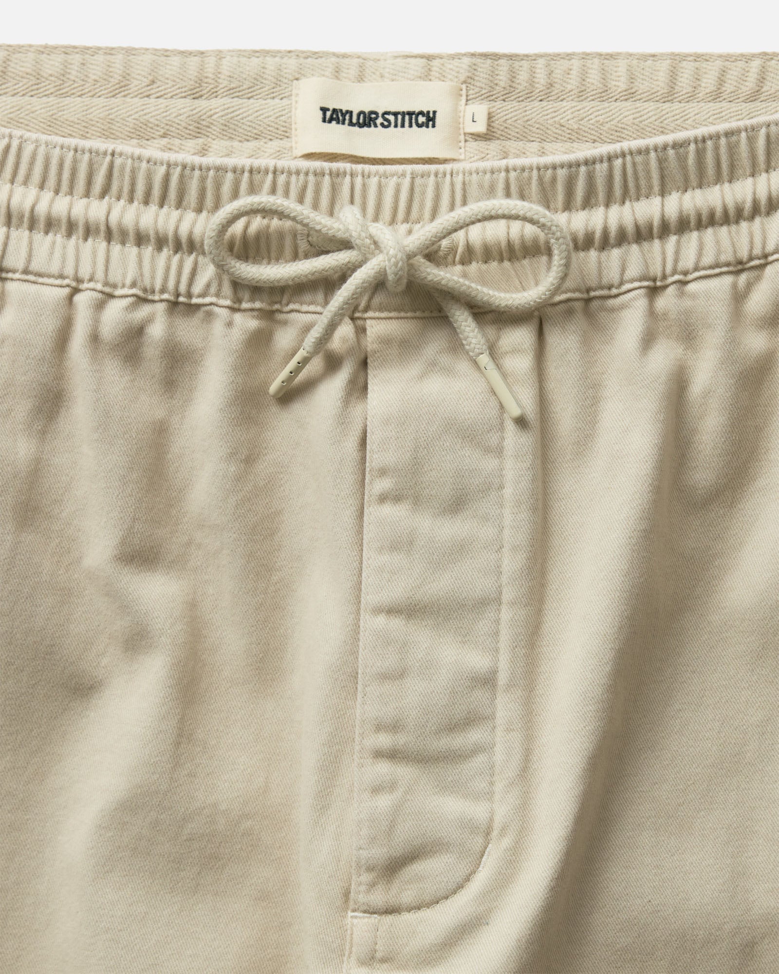 material shot of the waistband on The Apres Short in Organic Aged Stone Foundation Twill, Bottoms by Taylor Stitch