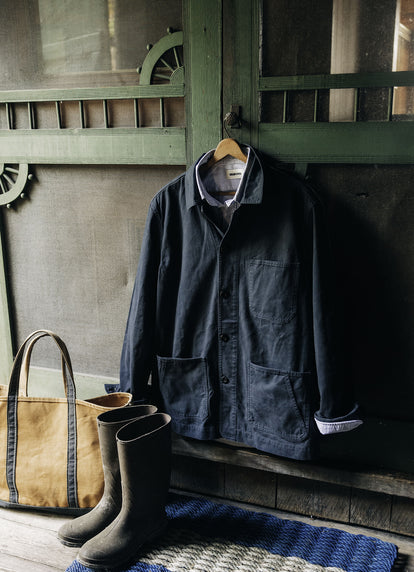 The Ojai Jacket in Navy Foundation Twill and The Jack in Navy University Stripe handing by the door