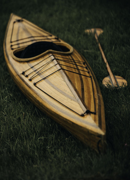 A wooden canoe on the grass