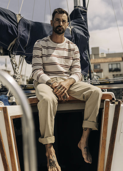 Model sitting on a yacht in The Colton Crew and The Matlow Pant