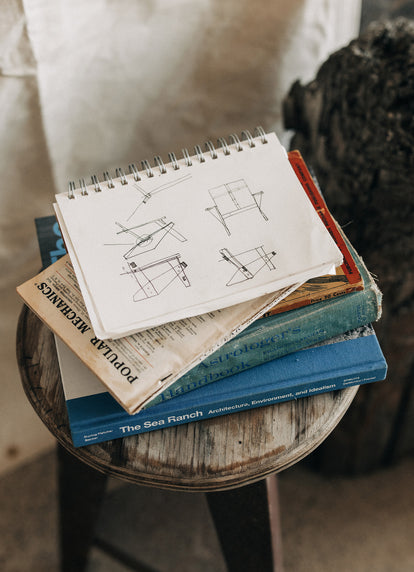 stack of notebooks and vintage books