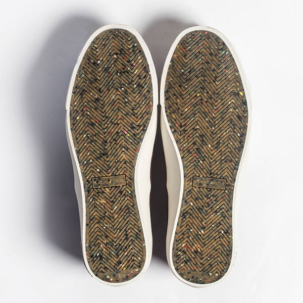 Studio flatlay of the sneaker soles.