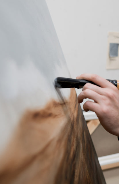 Shane applying a brush to the canvas.