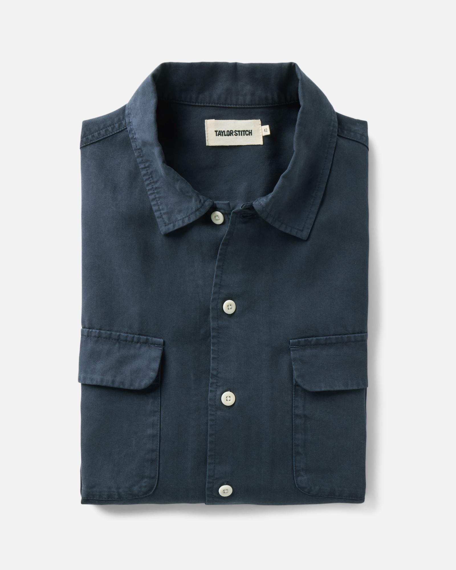 folded flatlay of The Shore Shirt in Navy Tencel, Wovens by Taylor Stitch