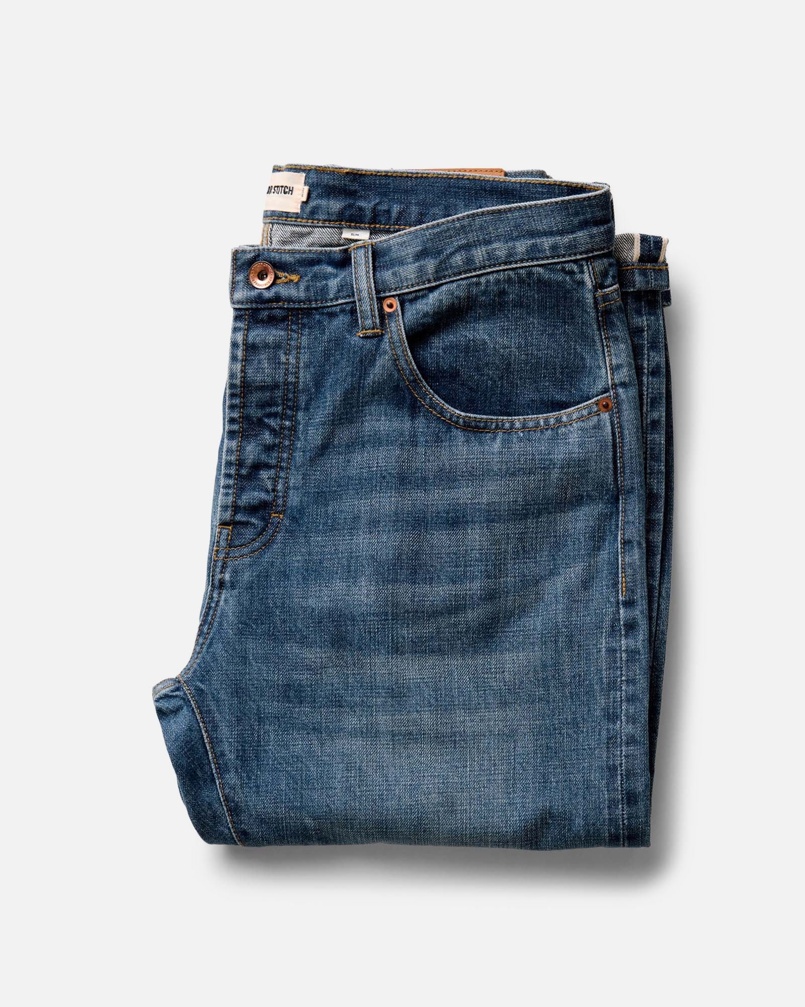 folded flatlay of The Slim Jean in Mid Wash Organic Selvedge, Bottoms by Taylor Stitch
