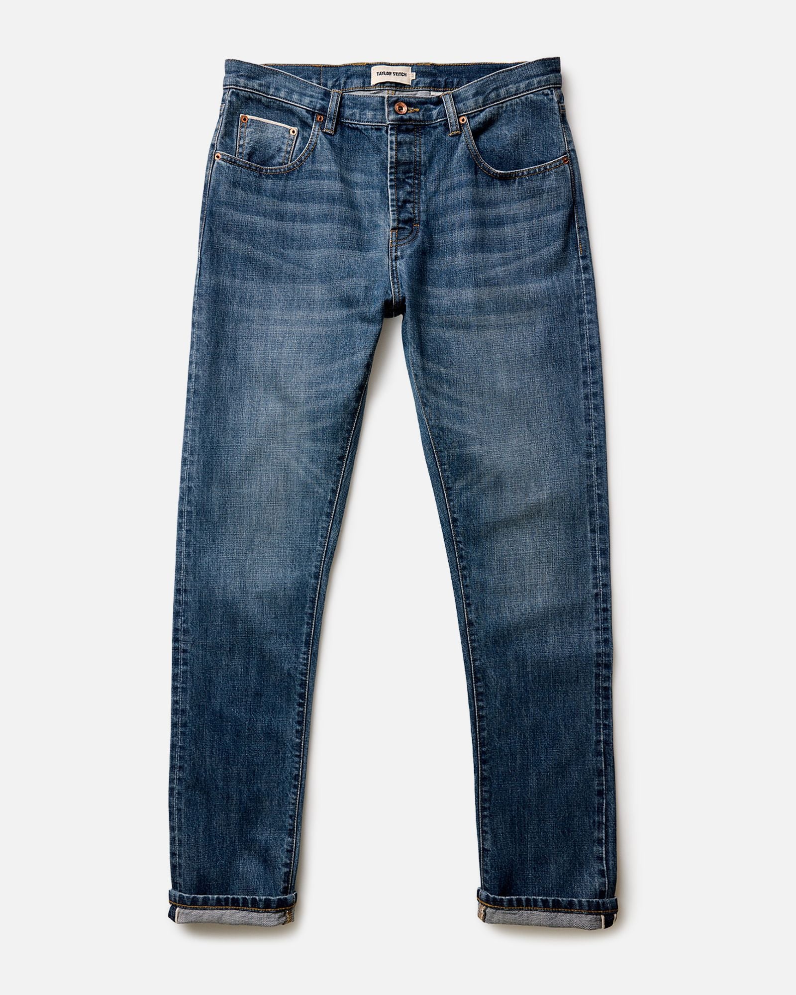 material shot of the button fly on The Slim Jean in Mid Wash Organic Selvedge, Bottoms by Taylor Stitch