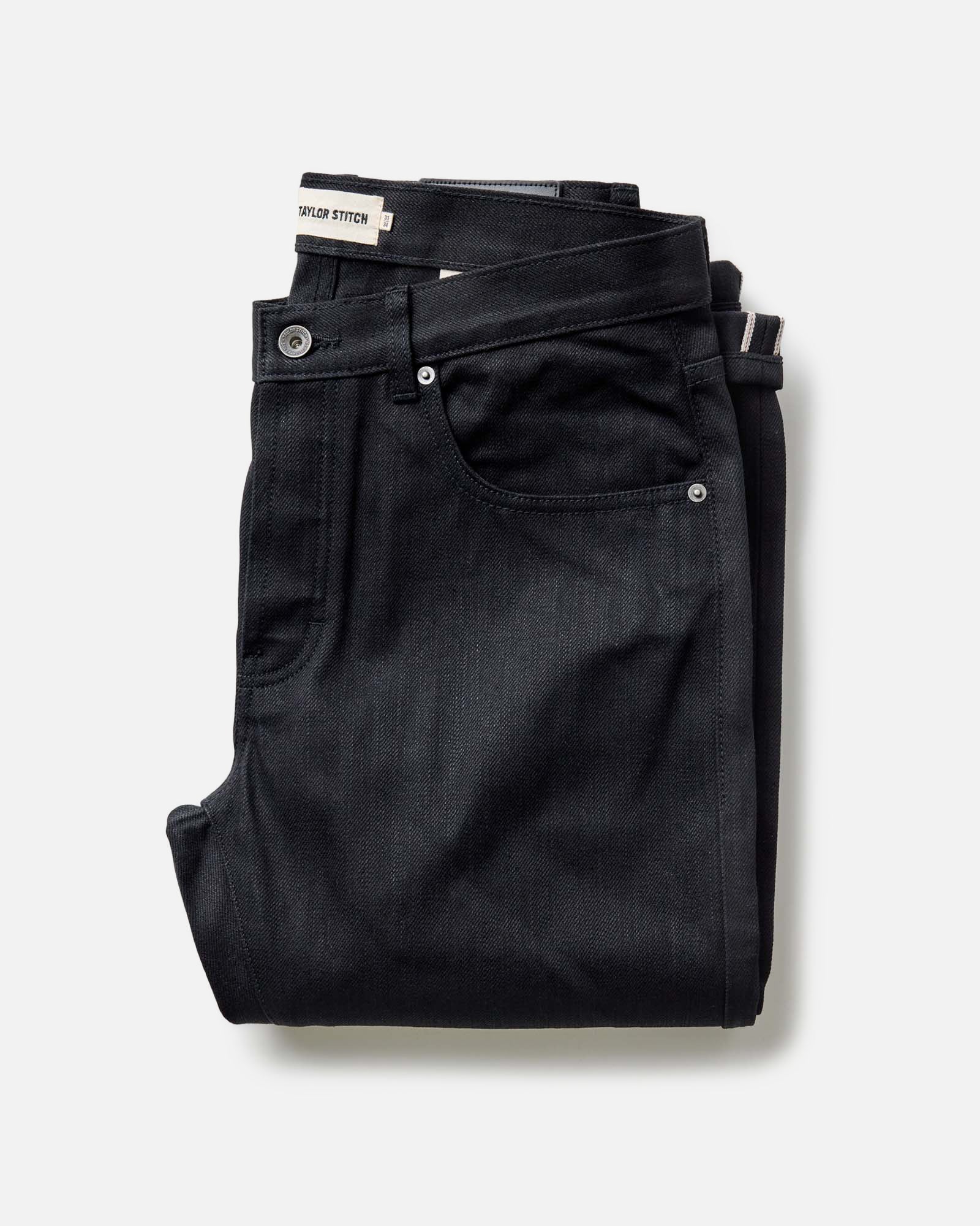 folded flatlay of The Slim Jean in Rigid Black Organic Selvedge, Bottoms by Taylor Stitch