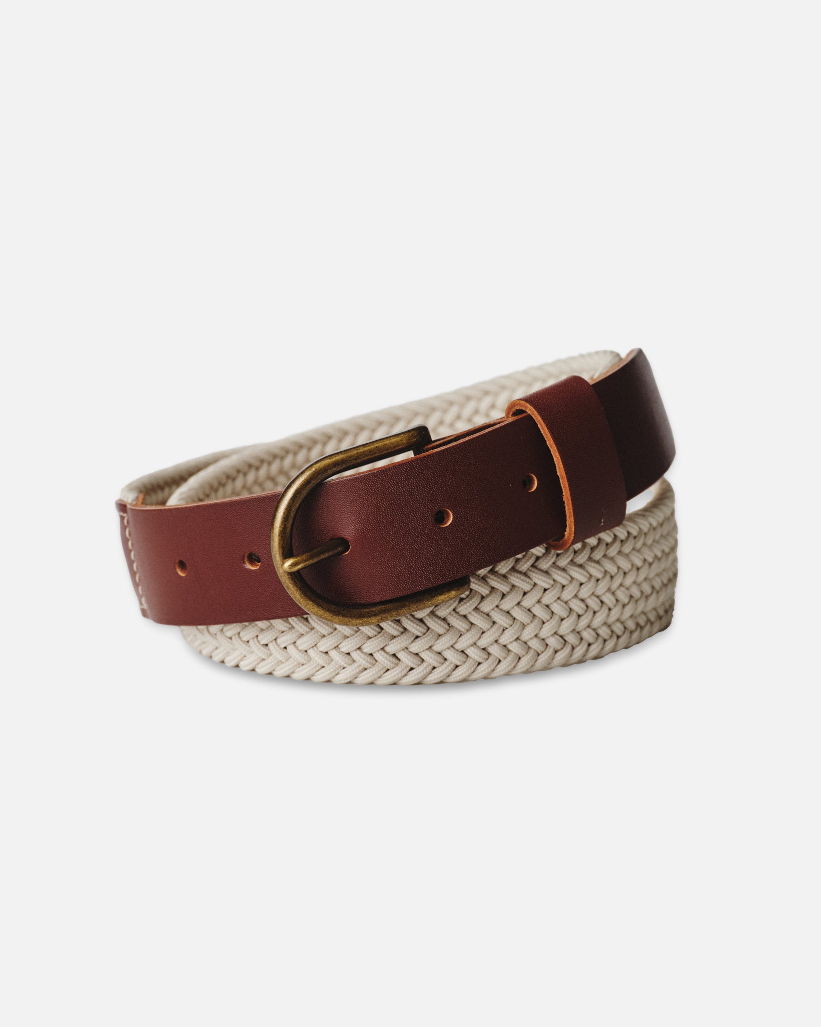 editorial image of The Stretch Braided Belt in Natural curled up, Accessories by Taylor Stitch