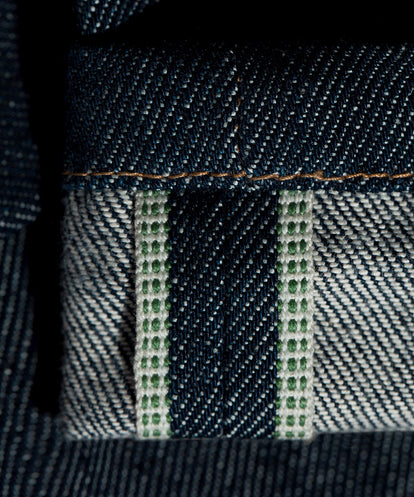 Close up on green-threaded selvage.