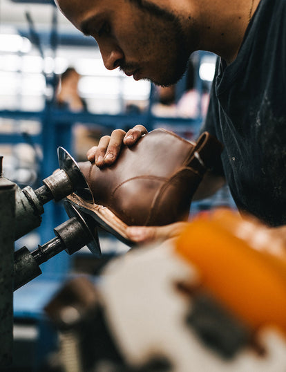 Trimming excess material from a boot.