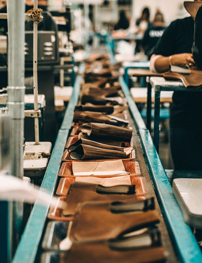 Looking down a short production line, uppers ready for assembly.