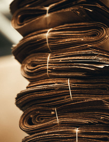 A stack of rolled, folded, and tied-up bundles of leather.