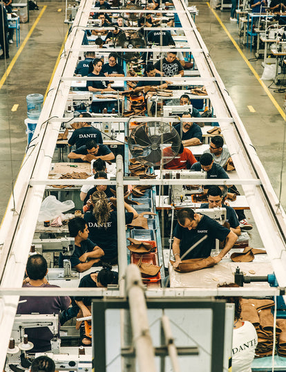 Overhead shot of several workers at their production stations.