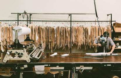 Patterns being cut with templates hanging in the background.