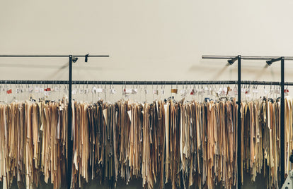 Garment patterns and templates hanging on a rack.