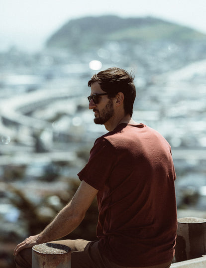 Our guy looking out over SF wearing a rust-colored merino tee.
