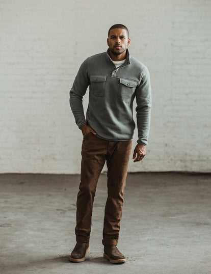 Our guy modeling the workwear pants in a well lit industrial interior.