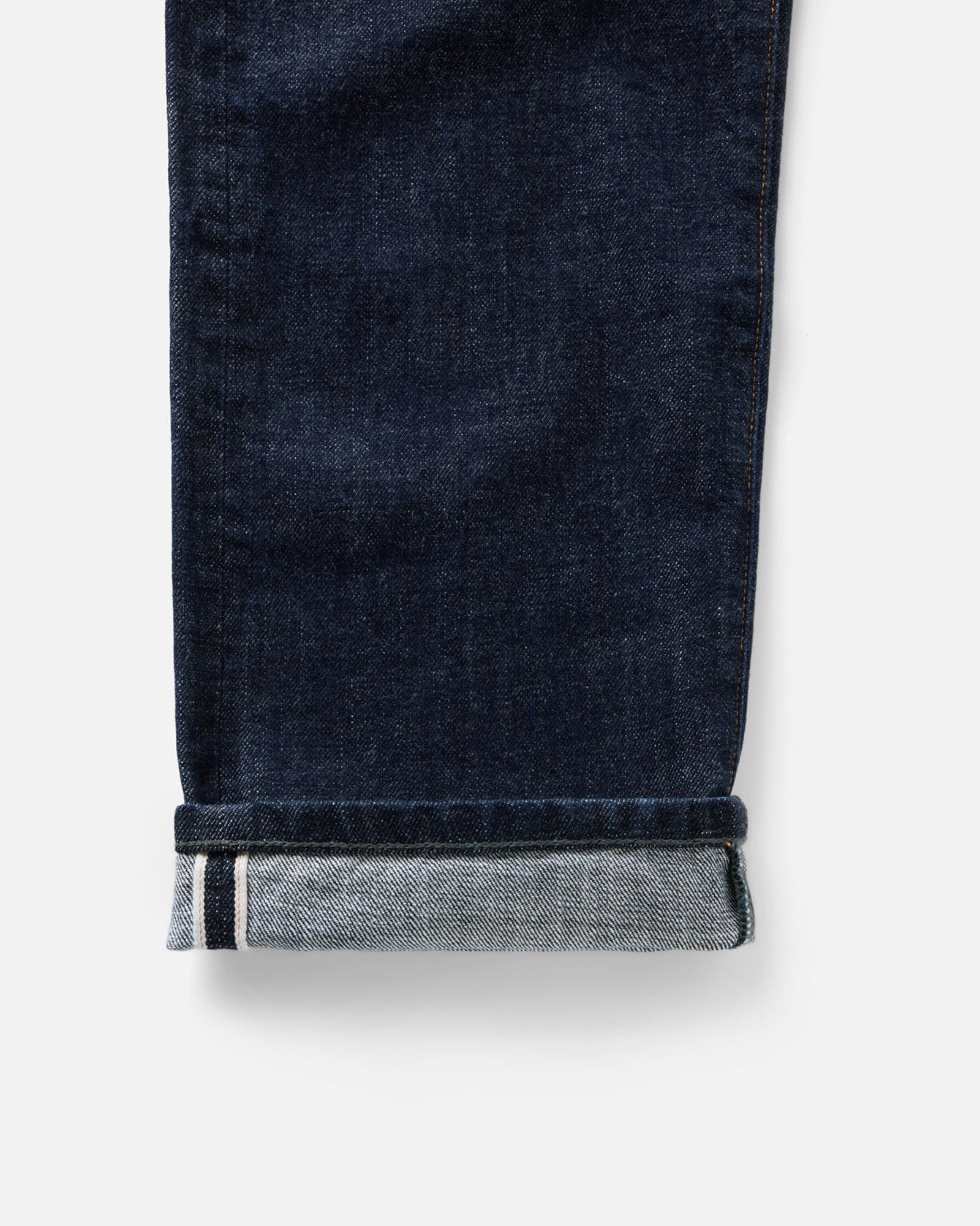 material shot of the bottom cuff on The Straight Jean in Rinsed Organic Selvedge, Bottoms by Taylor Stitch