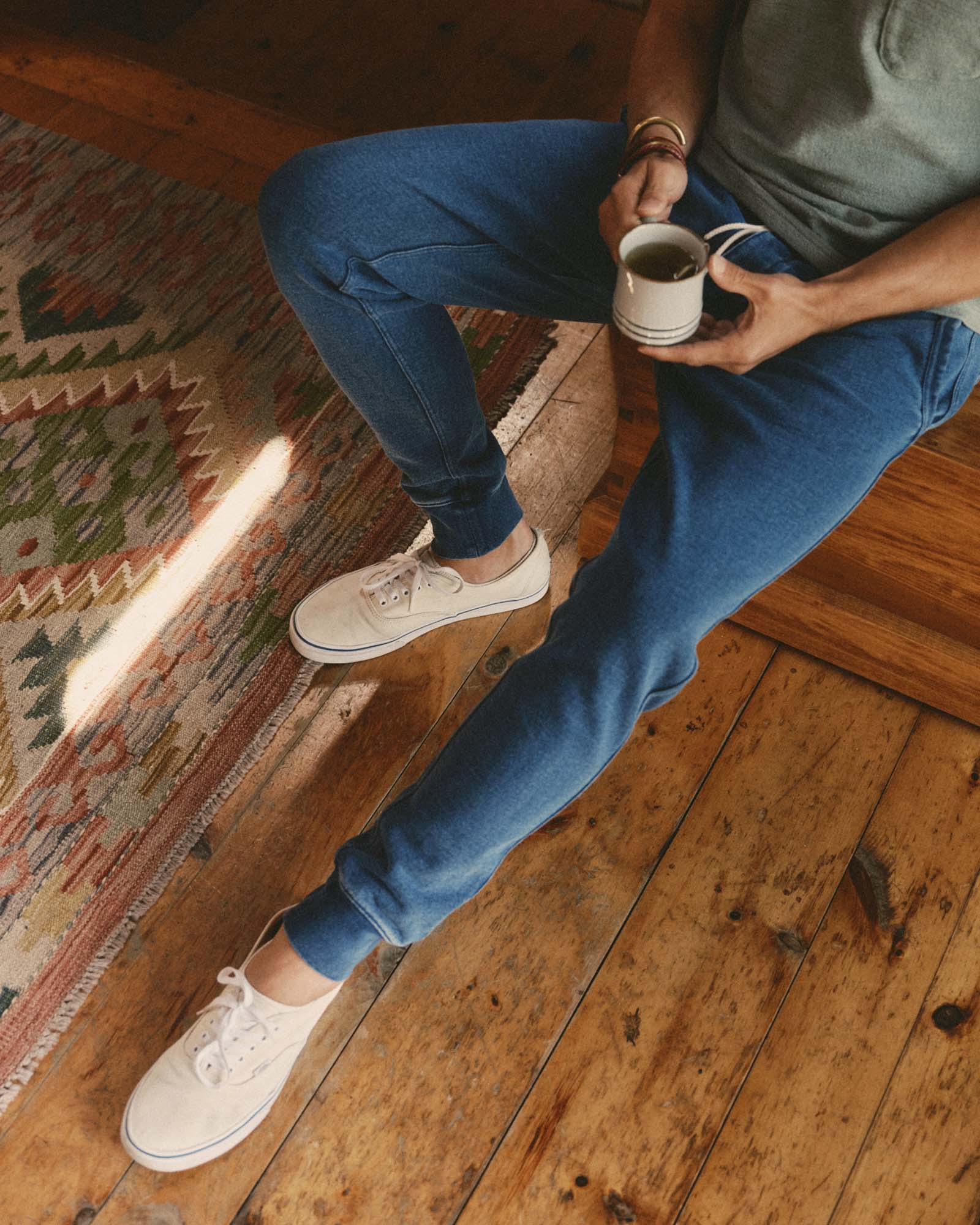 fit model sitting wearing The Sunset Pant in Washed Indigo Terry, Bottoms by Taylor Stitch