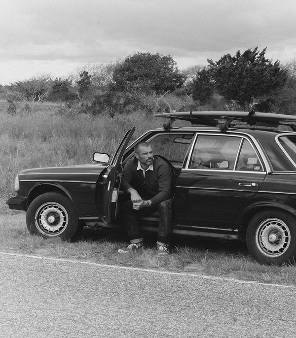 Models sitting around a vintage Mercedes in Montauk