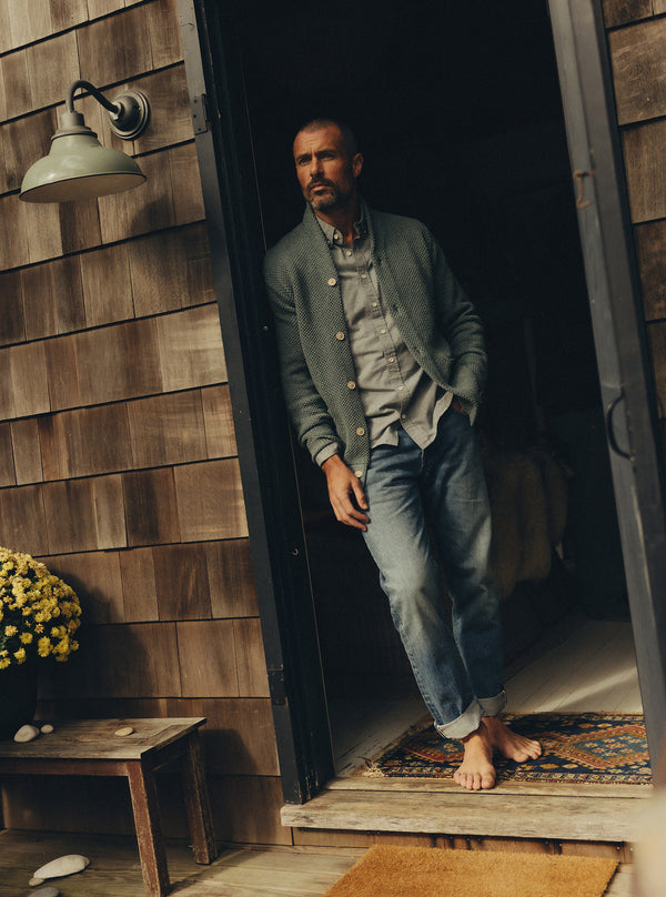 Model wearing the Crawford Sweater, leaning against a doorframe