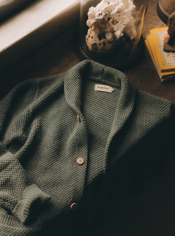 The Crawford Sweater in Deep Sea Twist on a wooden table